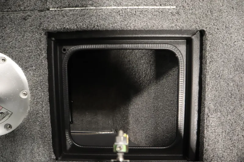 Slide: The Image of 2024 Tracker Pro Guide V-16 WT interior compartment detail with gray carpeted finish. - 19