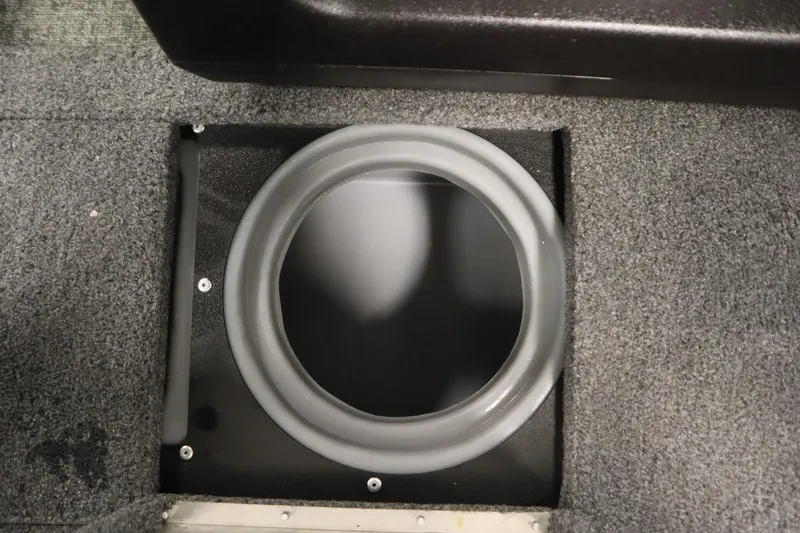 Slide: The Image of 2024 Tracker Pro Guide V-16 WT boat storage compartment with circular opening and carpeted interior. - 20