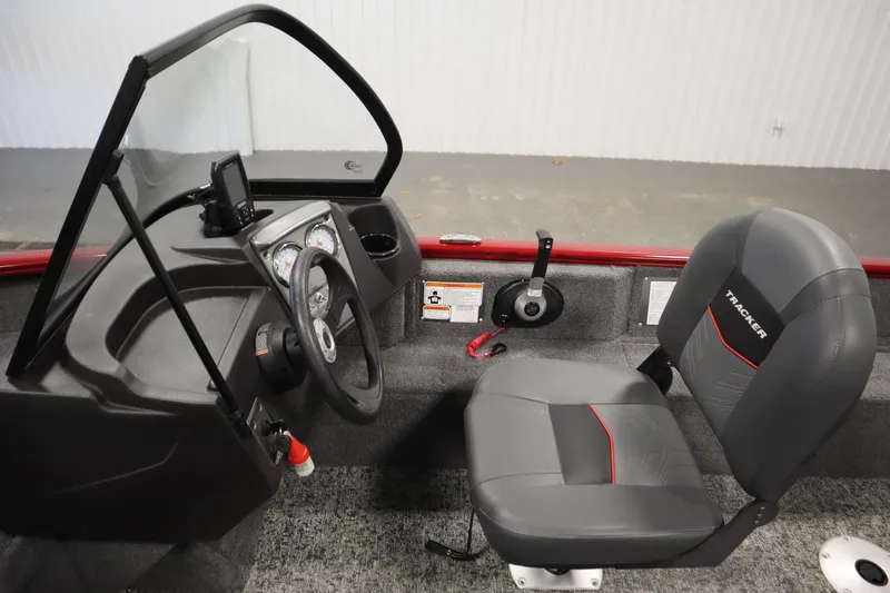 Slide: The Image of 2024 Tracker Pro Guide V-16 WT boat interior with steering wheel and seat. - 22