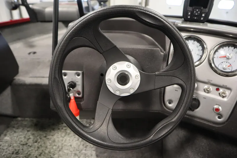 Slide: The Image of 2024 Tracker Pro Guide V-16 WT boat steering wheel and dashboard controls. - 24