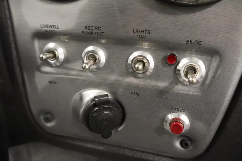 Slide: The Image of 2024 Tracker Pro Guide V-16 WT control panel with switches and buttons. - 27