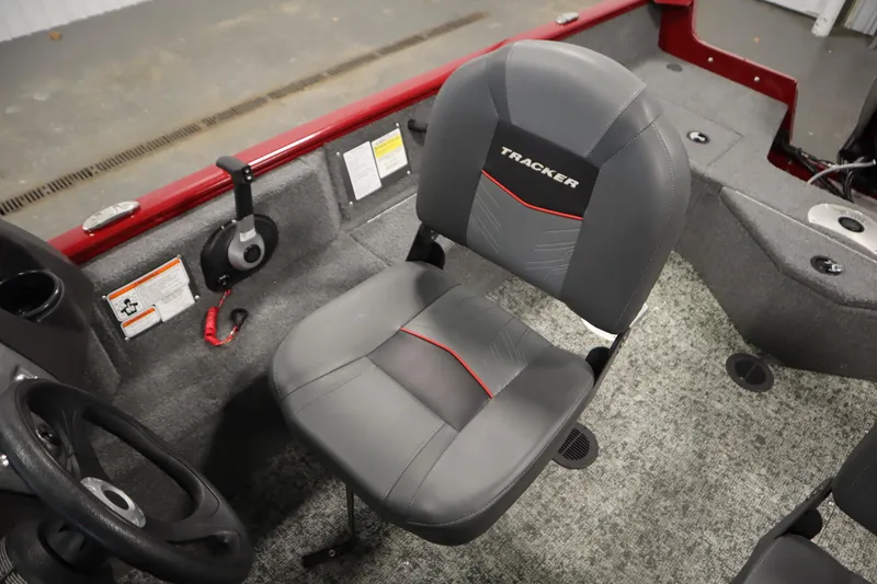 Slide: The Image of 2024 Tracker Pro Guide V-16 WT boat interior with gray seat and steering wheel. - 28