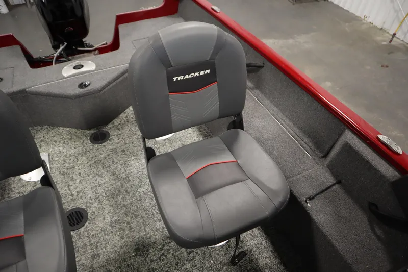 Slide: The Image of 2024 Tracker Pro Guide V-16 WT boat interior with gray seating and red accents. - 32