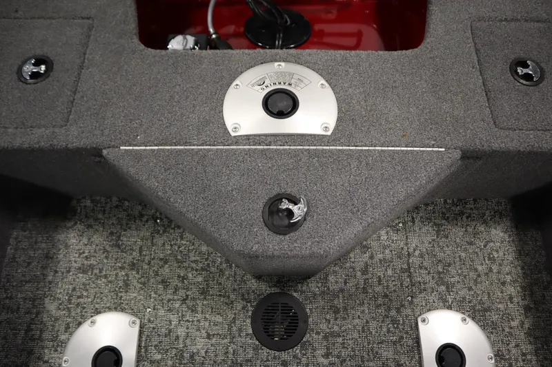 Slide: The Image of 2024 Tracker Pro Guide V-16 WT boat interior with carpeted flooring and storage compartments. - 38