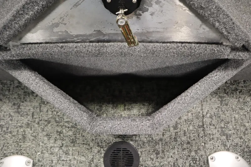 Slide: The Image of 2024 Tracker Pro Guide V-16 WT interior, featuring carpeted storage and metal fixtures. - 39