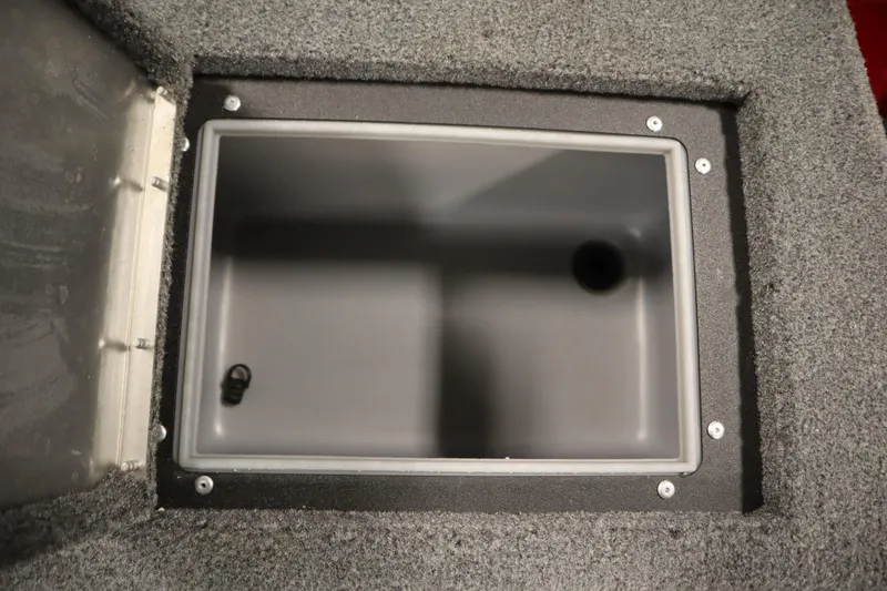 Slide: The Image of 2024 Tracker Pro Guide V-16 WT storage compartment with gray interior and carpeted edges. - 43