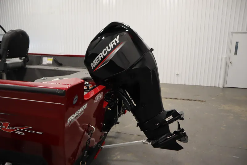 Slide: The Image of 2024 Tracker Pro Guide V-16 WT boat with Mercury outboard motor in a showroom. - 44