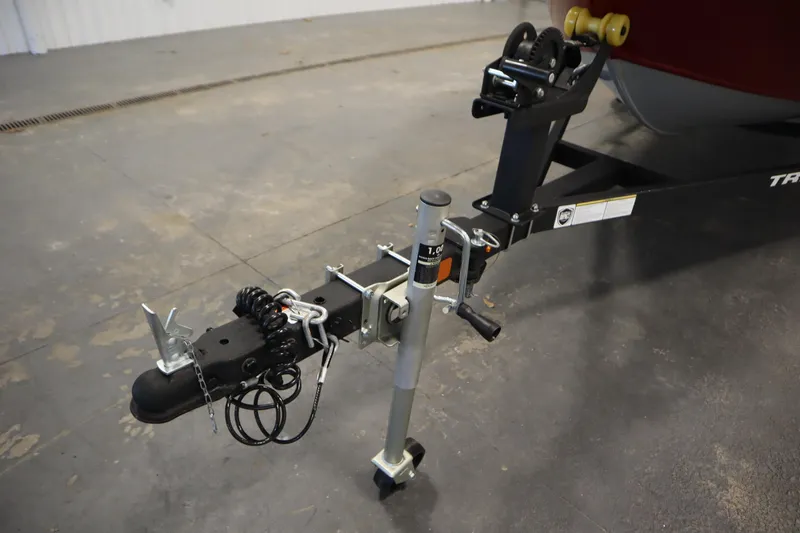 Slide: The Image of 2024 Tracker Pro Guide V-16 WT trailer hitch and winch system in a garage setting. - 48