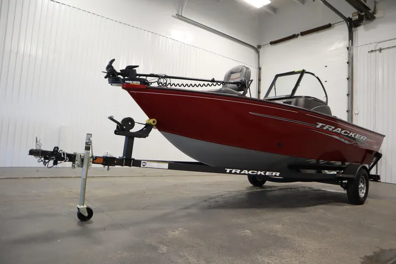 Slide: The Image of 2024 Tracker Pro Guide V-16 WT boat on trailer in indoor setting. - 49