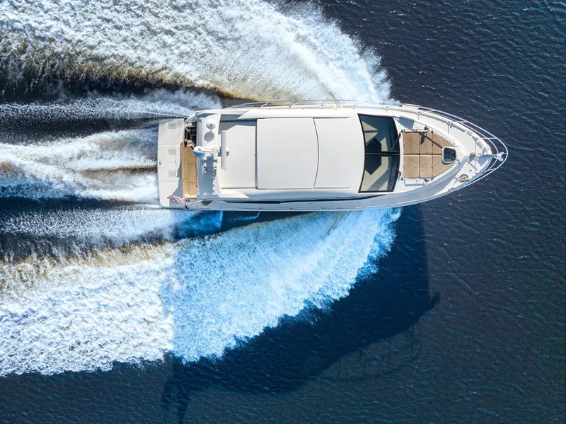 Slide: The Image of 2017 Sea Ray 460 Sundancer yacht cruising on open water, aerial view. - 11