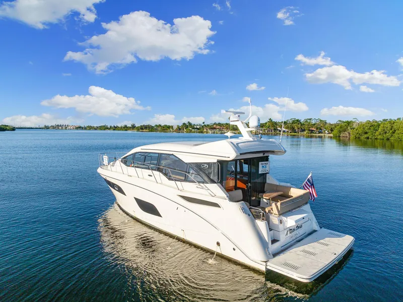 Slide: The Image of 2017 Sea Ray 460 Sundancer yacht on serene water under blue sky. - 12