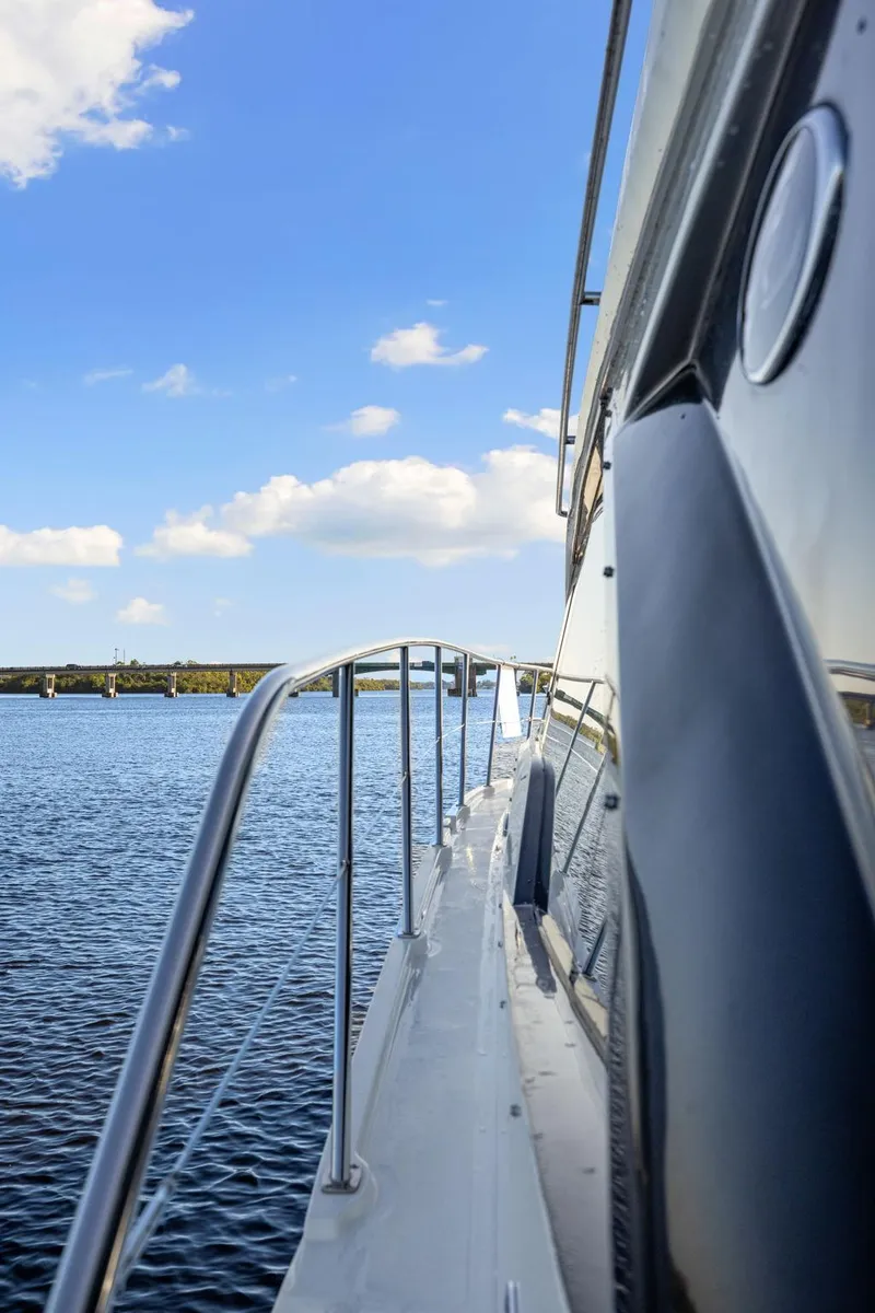 Slide: The Image of Side view of 2017 Sea Ray 460 Sundancer yacht on calm water under blue sky. - 15