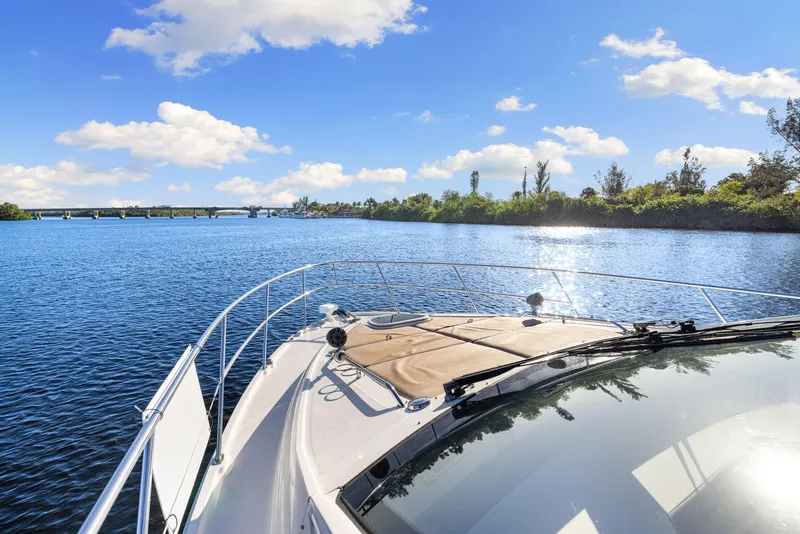 Slide: The Image of Sea Ray 460 Sundancer 2017 cruising on a sunny day, scenic waterway view. - 16
