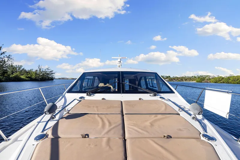 Slide: The Image of 2017 Sea Ray 460 Sundancer yacht on a sunny day, cruising on calm waters. - 17