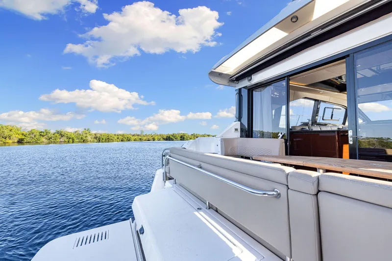 Slide: The Image of 2017 Sea Ray 460 Sundancer yacht on serene blue water under a clear sky. - 19