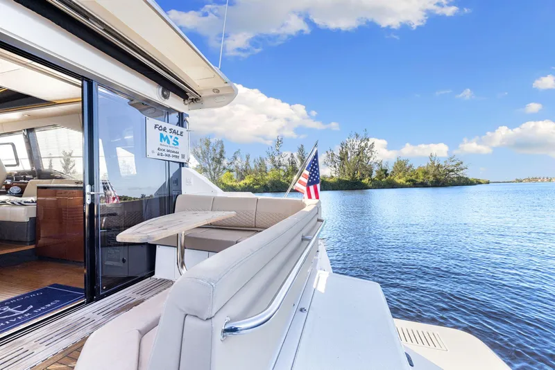 Slide: The Image of 2017 Sea Ray 460 Sundancer yacht for sale, docked by serene waters. - 21