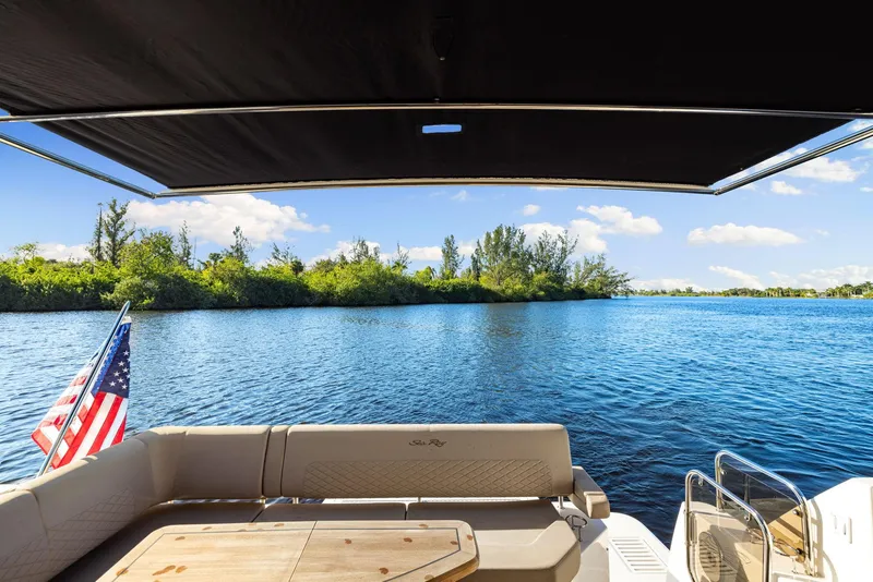 Slide: The Image of 2017 Sea Ray 460 Sundancer yacht with scenic water view and American flag. - 24