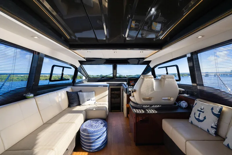 Slide: The Image of Luxurious interior of 2017 Sea Ray 460 Sundancer yacht with plush seating and panoramic windows. - 26