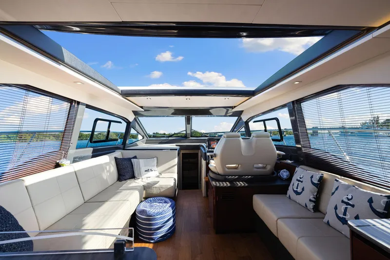 Slide: The Image of Luxurious interior of 2017 Sea Ray 460 Sundancer yacht with panoramic windows and plush seating. - 27