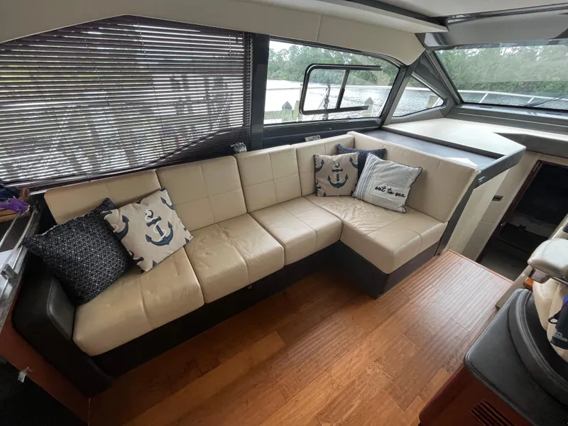 Slide: The Image of Interior of 2017 Sea Ray Sundancer 460 yacht with beige sofa and nautical pillows. - 29