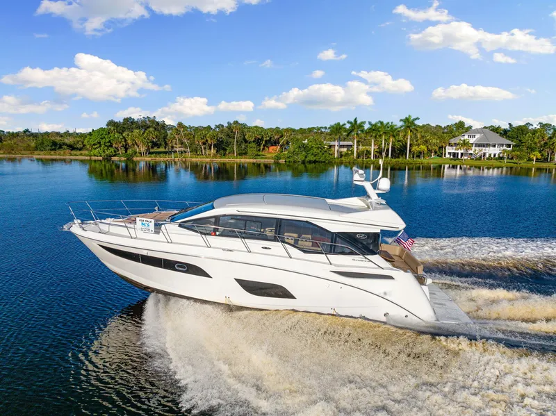 Slide: The Image of 2017 Sea Ray 460 Sundancer yacht cruising on a scenic lake. - 3