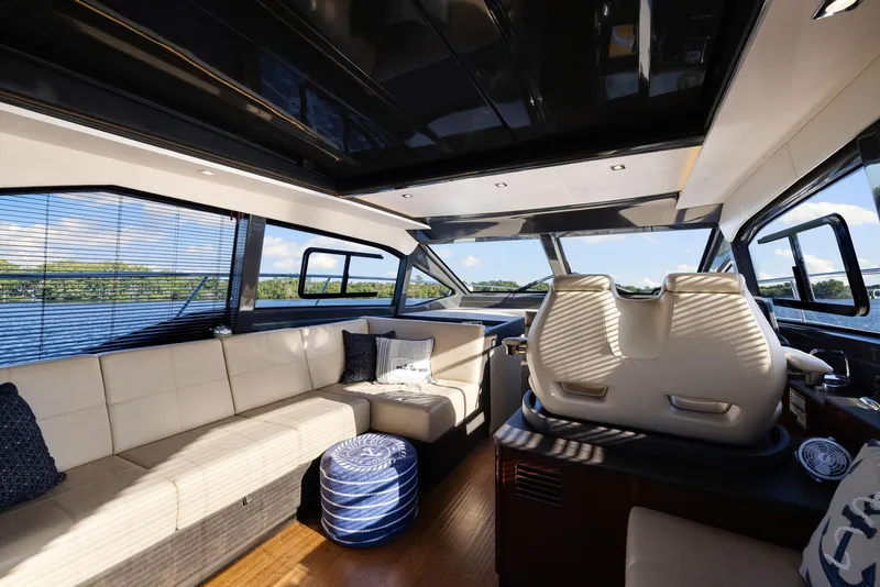 Slide: The Image of Luxurious interior of 2017 Sea Ray 460 Sundancer yacht with plush seating and panoramic windows. - 30