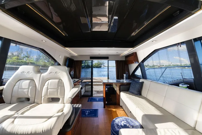 Slide: The Image of Luxurious interior of 2017 Sea Ray 460 Sundancer yacht with plush seating and panoramic windows. - 34