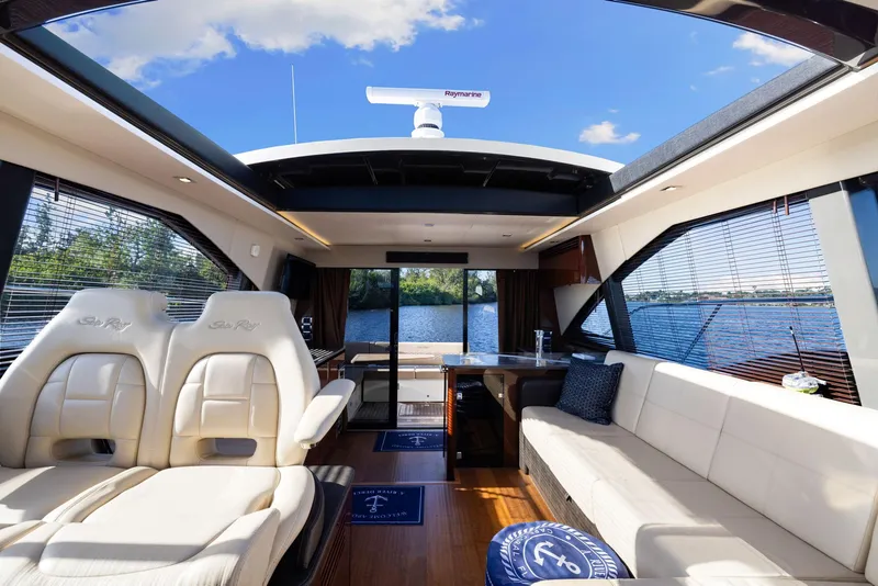 Slide: The Image of Luxurious interior of 2017 Sea Ray 460 Sundancer yacht with panoramic windows and plush seating. - 35