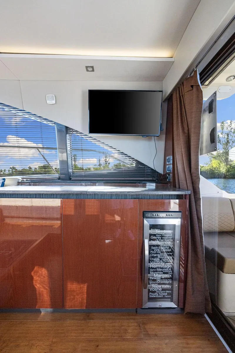 Slide: The Image of Interior of 2017 Sea Ray 460 Sundancer yacht with TV and mini fridge. - 47
