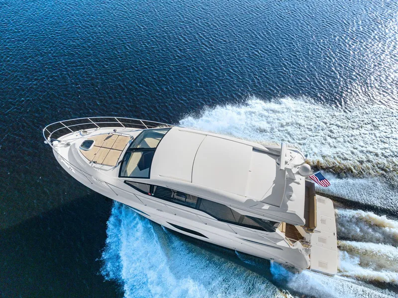 Slide: The Image of 2017 Sea Ray 460 Sundancer yacht cruising on open water, aerial view. - 5