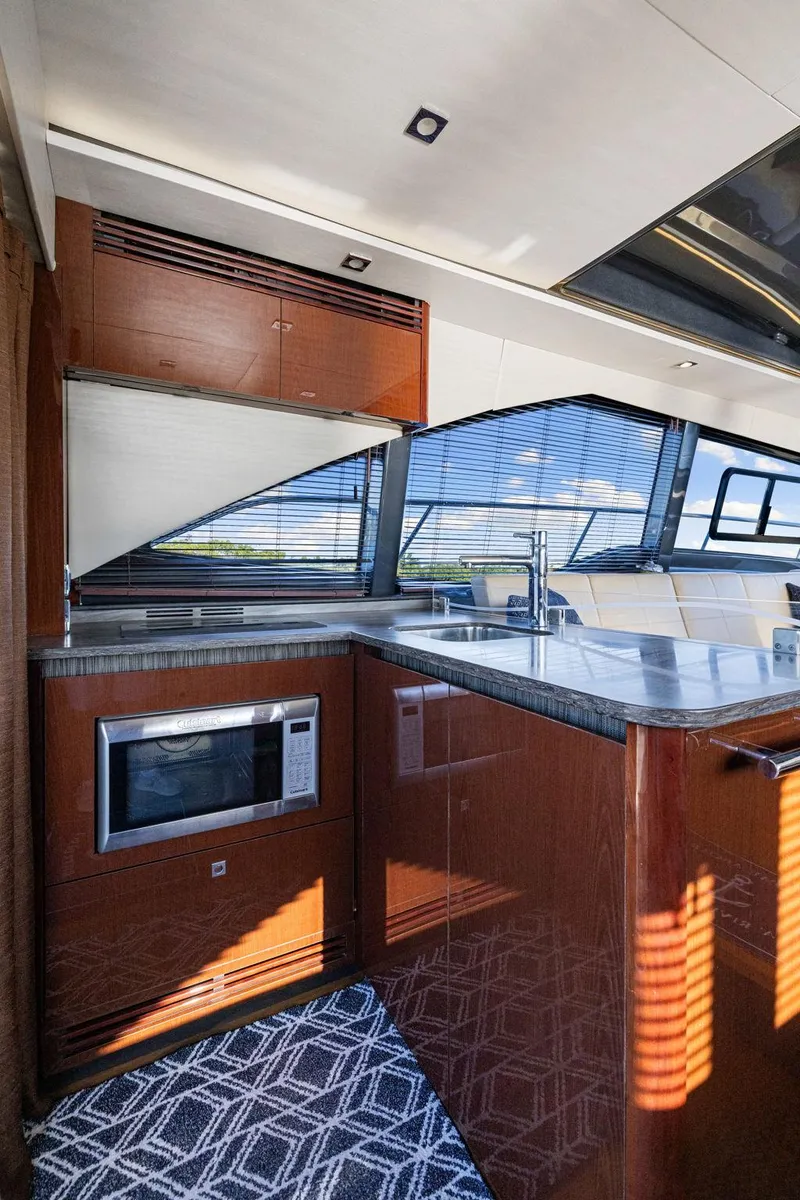 Slide: The Image of Luxurious 2017 Sea Ray 460 Sundancer yacht interior with modern kitchen amenities. - 52