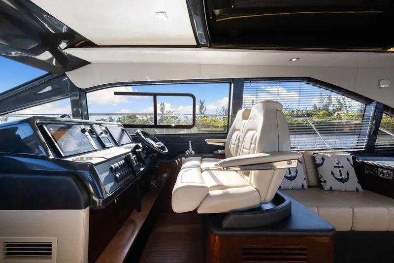 Slide: The Image of Interior of 2017 Sea Ray 460 Sundancer yacht with luxurious helm and seating. - 59