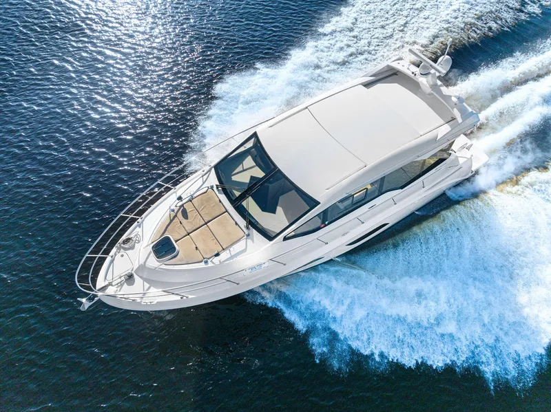 Slide: The Image of 2017 Sea Ray 460 Sundancer yacht cruising on open water. - 6