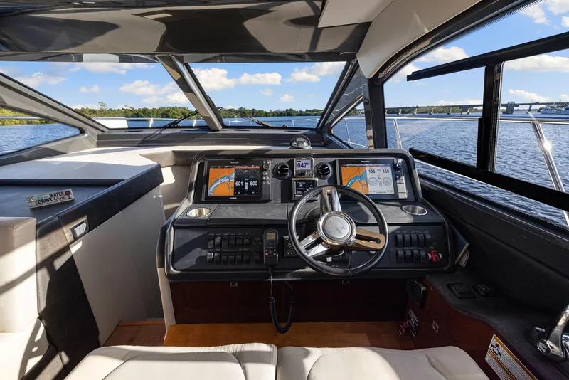 Slide: The Image of Interior helm of 2017 Sea Ray 460 Sundancer yacht with modern navigation displays. - 68