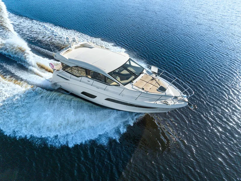 Slide: The Image of 2017 Sea Ray 460 Sundancer cruising on open water, aerial view. - 7