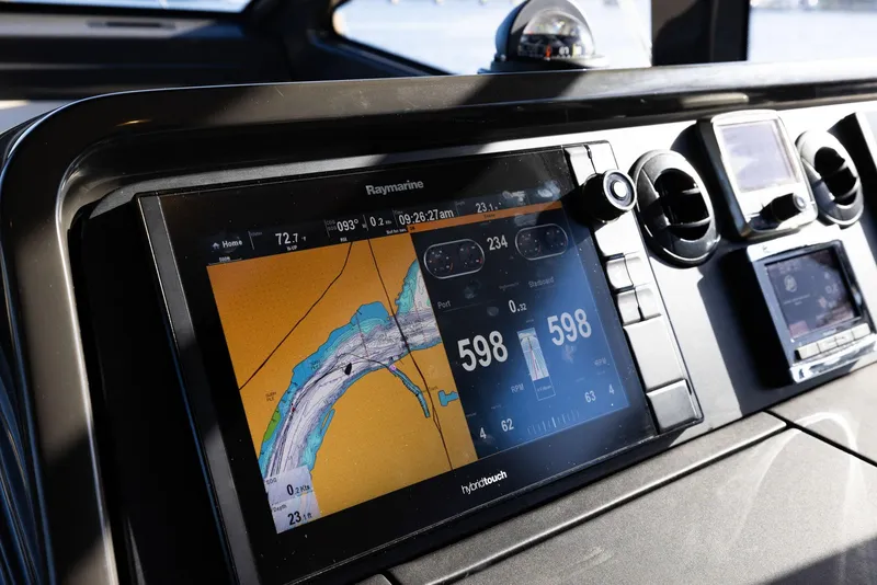 Slide: The Image of Sea Ray 460 Sundancer 2017 dashboard with navigation display and controls. - 77