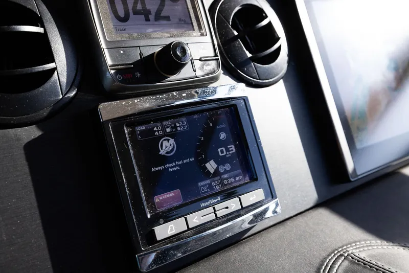 Slide: The Image of Control panel of 2017 Sea Ray 460 Sundancer boat, featuring navigation and display screens. - 79