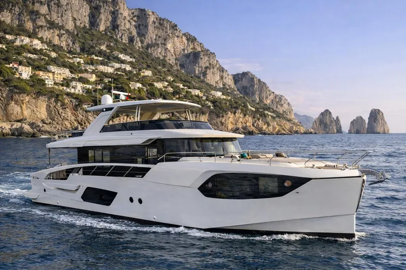The Image of Luxury Absolute 70 Navetta yacht cruising near scenic cliffs, 2026 model. - 0