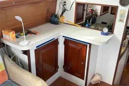 Slide: The Image of 1979 Mainship 34 Trawler interior with wooden cabinets and countertop accessories. - 3