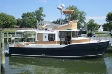 The Image of 2021 Ranger Tugs R-31 CB boat docked on a sunny day, surrounded by trees. - 0