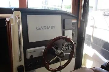 Slide: The Image of 2021 Ranger Tugs R-31 CB helm with Garmin navigation system and wooden steering wheel. - 16