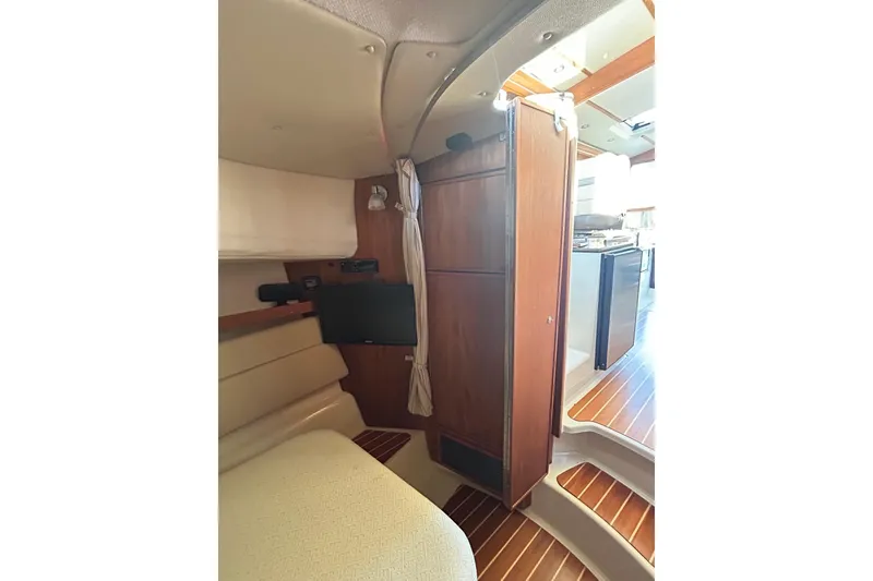 Slide: The Image of Interior of 2021 Ranger Tugs R-31 CB, featuring wood paneling and compact living space. - 21