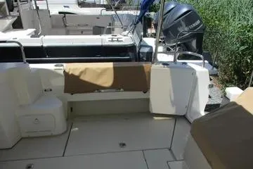 Slide: The Image of 2021 Ranger Tugs R-31 CB boat deck with seating and outboard motor. - 4