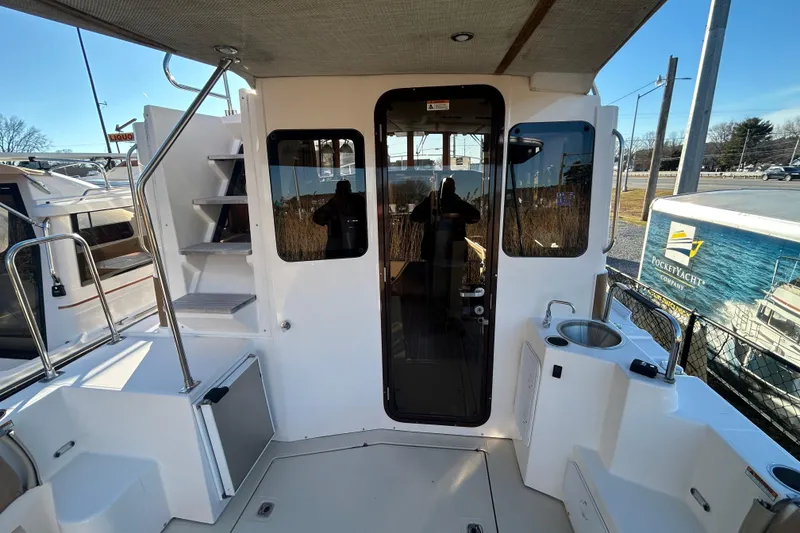 Slide: The Image of 2021 Ranger Tugs R-31 CB boat deck with stairs and glass door. - 7
