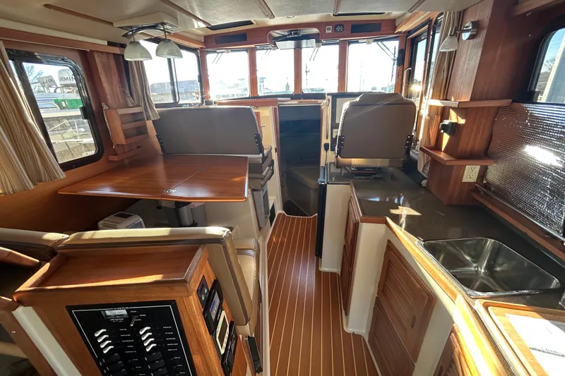 Slide: The Image of Interior of 2021 Ranger Tugs R-31 CB, featuring wood finishes and modern amenities. - 9