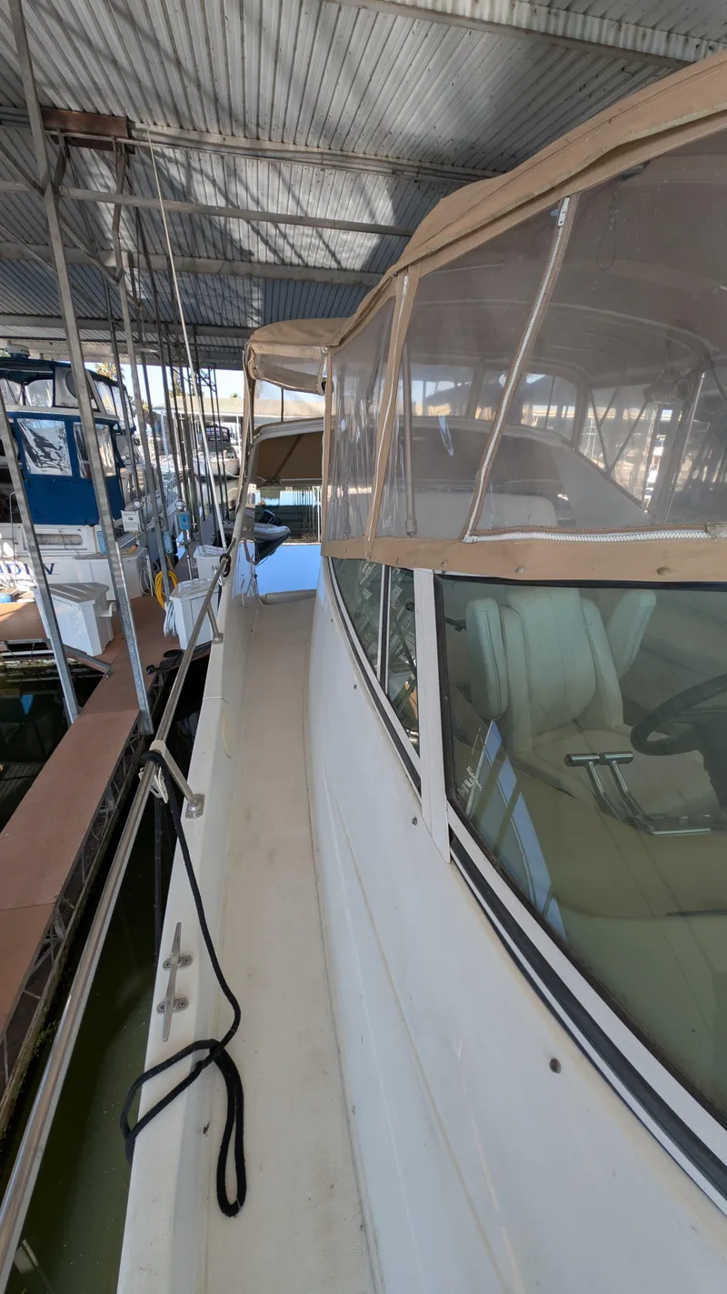 Slide: The Image of 2002 Carver 350 Mariner yacht docked, side view. - 21