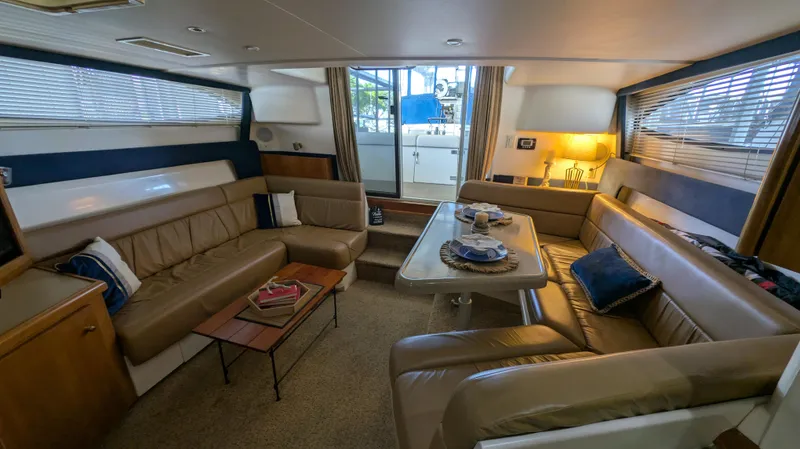 Slide: The Image of Interior of 2002 Carver 350 Mariner with leather sofas and dining table. - 23