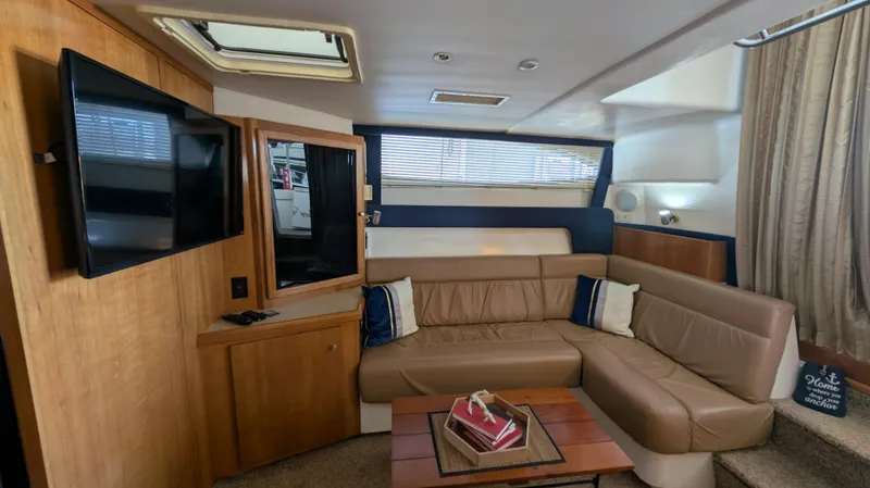Slide: The Image of Interior of 2002 Carver 350 Mariner with leather sofa and TV. - 24