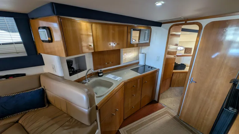 Slide: The Image of Interior of 2002 Carver 350 Mariner with kitchen and seating area. - 26