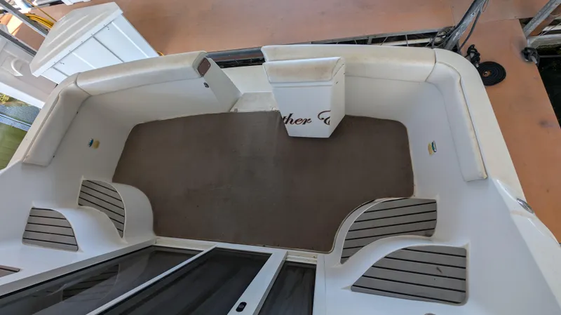 Slide: The Image of Deck area of a 2002 Carver 350 Mariner boat, featuring seating and carpet. - 8